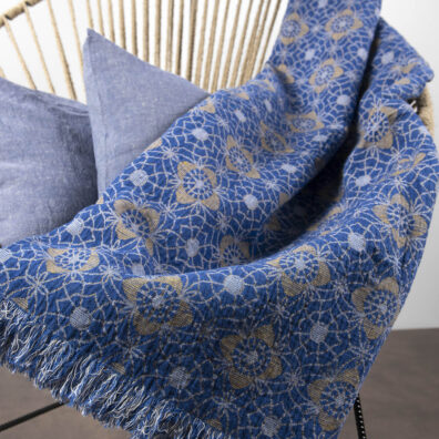 plaid de lin-coton double face où un côté est à fleurs jaunes sur le fond bleu.