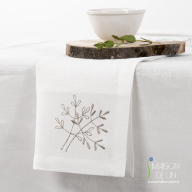 Serviette de lin blanc cassé avec de broderie beige.